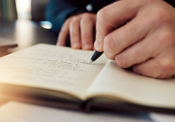 istock Hands, writing and closeup in office, notebook and idea for project, schedule or marketing with vision. Man, planning and paper with pen, notes and strategy for brainstorming, solution or development 1643815816