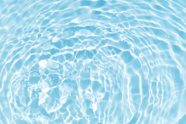 istock Blue water with ripples on the surface. Defocus blurred transparent blue colored clear calm water surface texture with splashes and bubbles. Water waves with shining pattern texture background. 1643818041