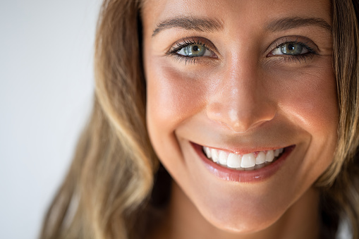 Face of beautiful woman smiling with white teeth.
