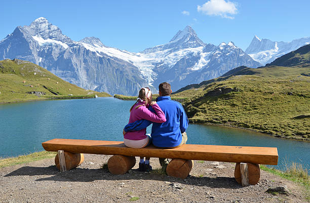 istock Travelers on a bench enjoying Alpine panorama 164383204