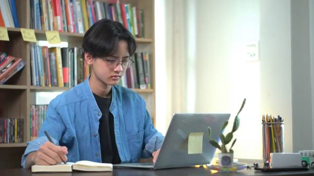 istock Young asian is working on laptop in the home. 1643843202
