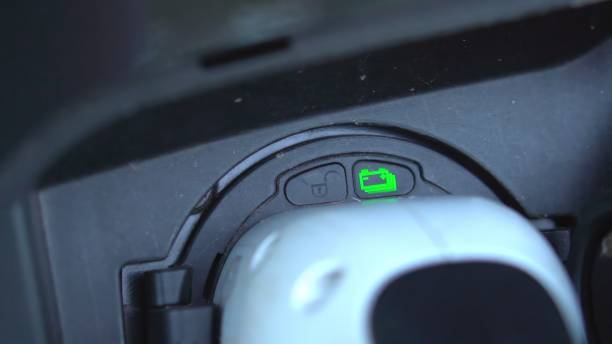 istock Open - close lid charging, Close up hand man  inserting plug into charging electric car. 1643844004