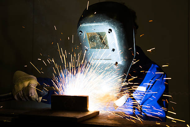 istock Man welding steel creating many sparks 164385852