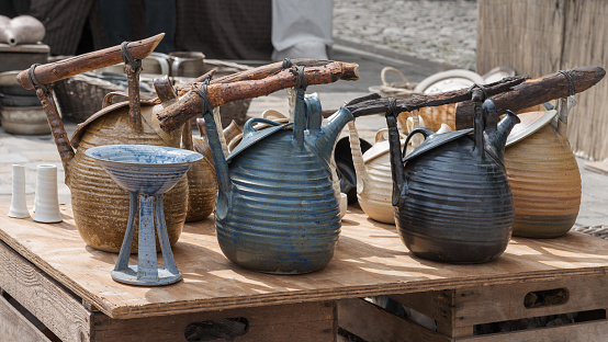 Vessels, teapots in rustic style. Clay crafting, Earthenware, Ceramic art. Tough, practical, utilitarian ware for the kitchen. Art ware, tableware, decorative ware. Fair of pottery on the city square