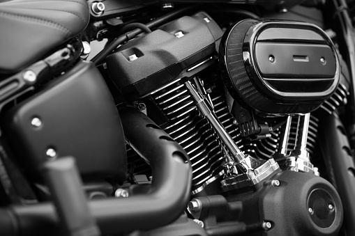 A close up of the engine fins of a black touring motorcycle.