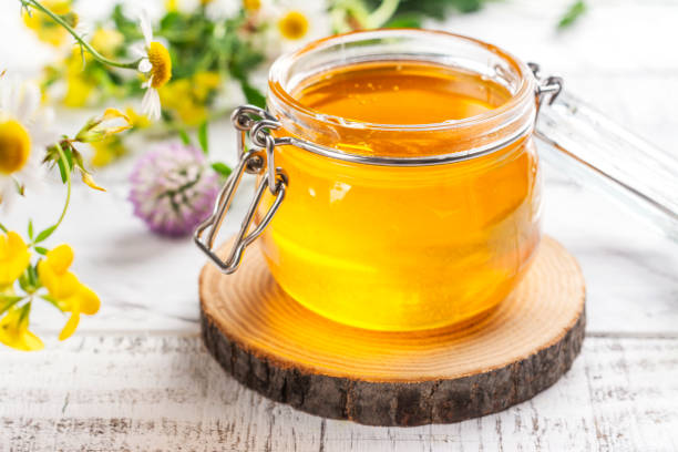 istock Glass jar with floral liquid honey 1643878714