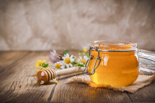 istock Glass jar with floral liquid honey 1643878762