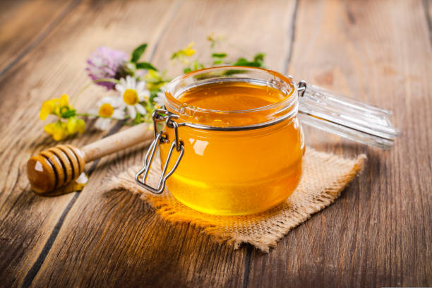 istock Glass jar with floral liquid honey 1643879304