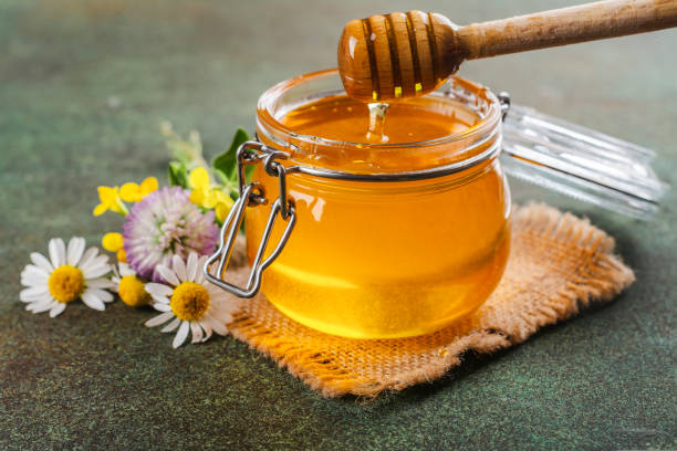 istock Glass jar with floral liquid honey 1643879305