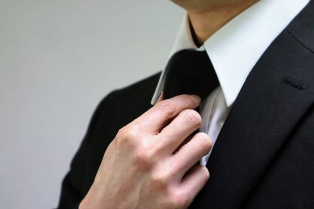 istock Japanese man changing into funeral clothes 1643916340