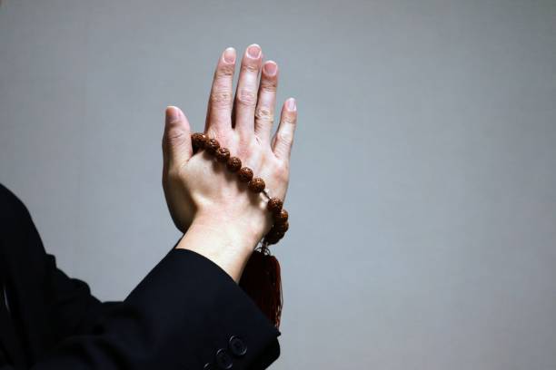 istock Person praying with beads 1643919040