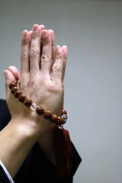 istock Person praying with beads 1643923445