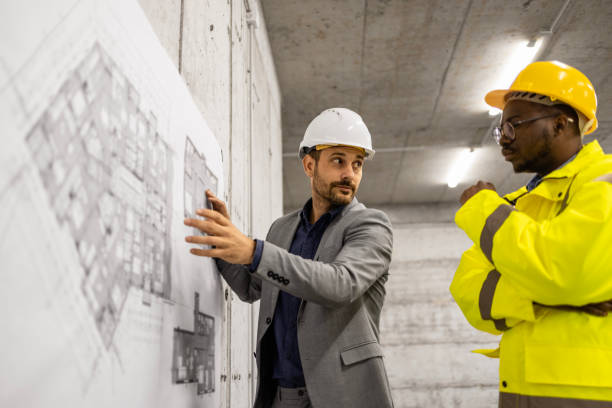 istock Construction engineer or architect presenting building plan and blueprint to the worker at the site. 1643926090