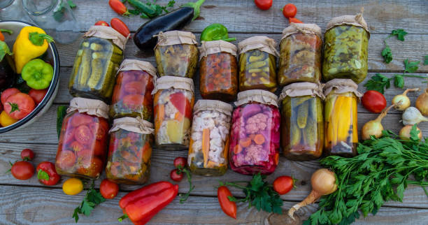 A woman preserves vegetables in jars. Selective focus
