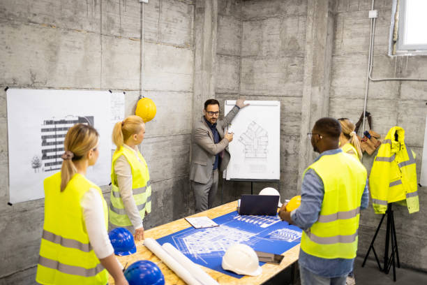 istock Team of structural engineers and architects having a meeting at construction site analyzing next phase of building. 1643929833