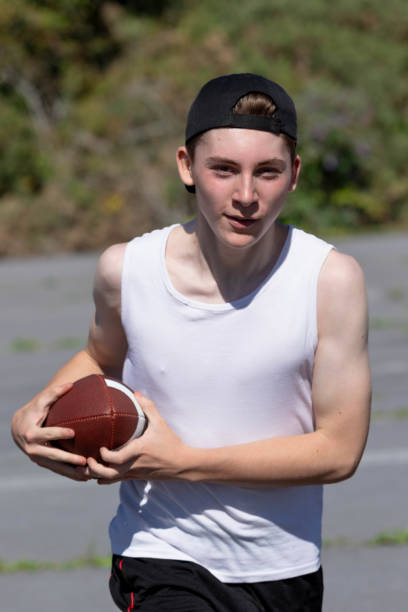 istock Running with an American Football 1643937606