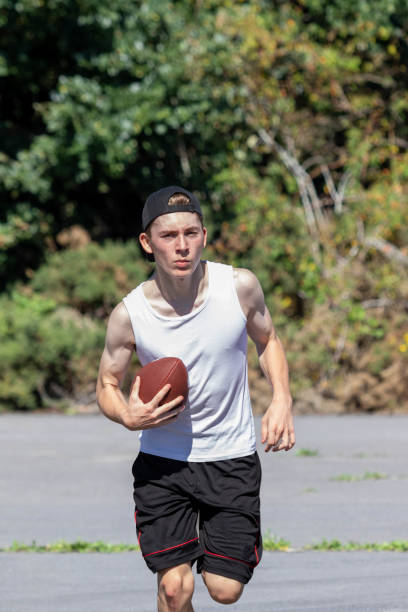 istock Running with an American Football 1643939319