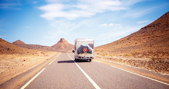 Motorhome on the road in the desert- road trip, travel destination, wanderlust concept