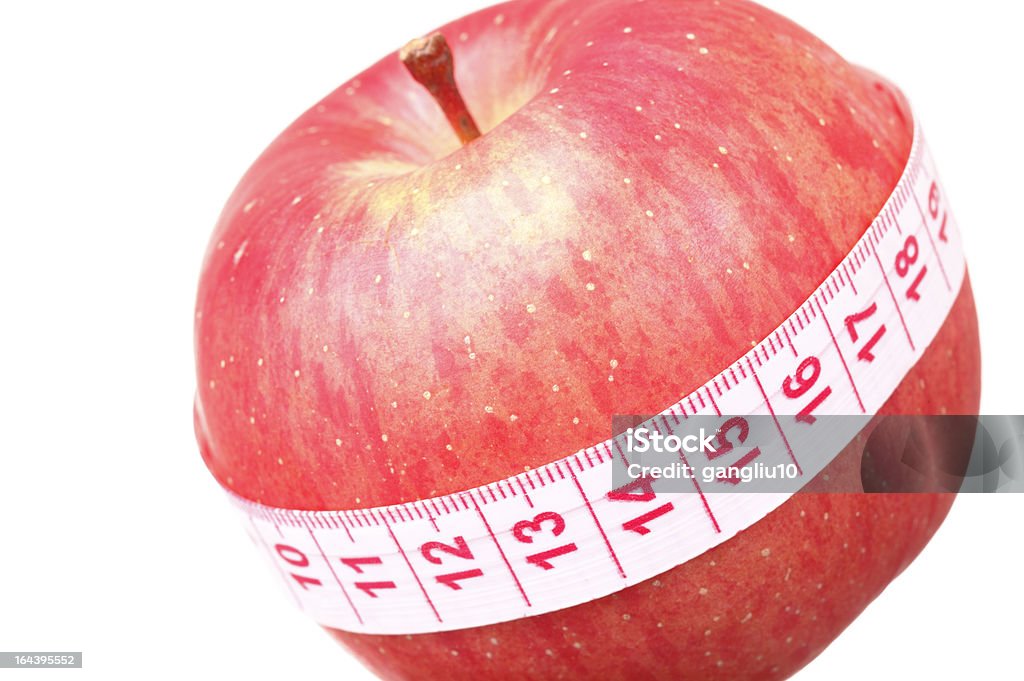 Healthy lifestyle Red apple with tape measure, isolated on white Apple - Fruit Stock Photo