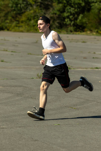 istock Teenage boy running outside 1643962219
