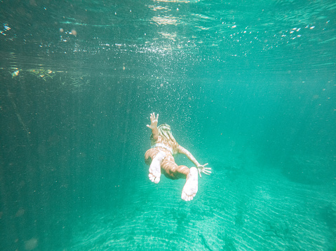 She explores the lake underground river, people on vacations, she adventures underwater