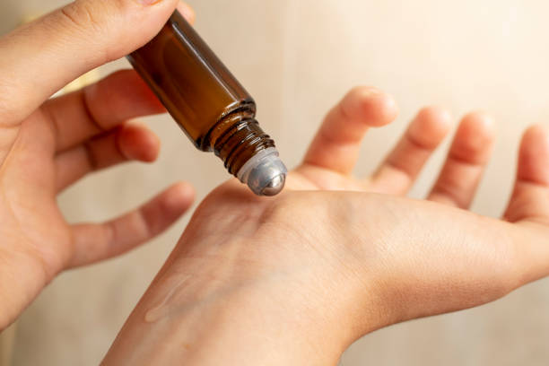 istock woman hands testing a roll on with essential oil , applying liquid on the wrist 1643965737