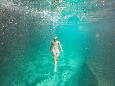 He explores the lake underground river, people on vacations, he adventures underwater