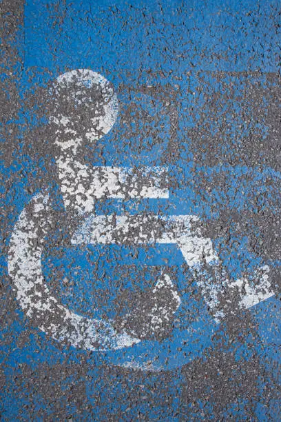 sign on a parking lot space reserved for people with physical disabilities, abstract texture