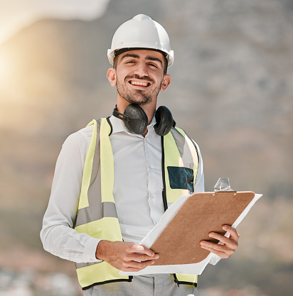 Portrait, engineering and happy man at construction site with checklist for inspection, project management and architecture. Maintenance, contractor or builder with smile and clipboard for safety.