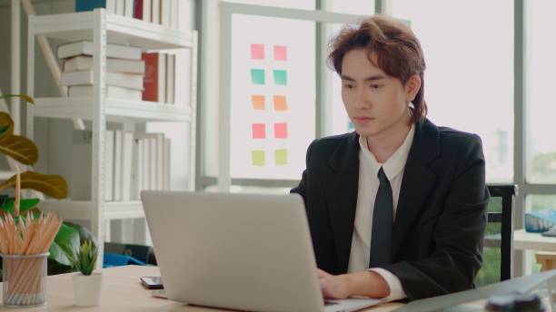 istock Asian man planning a business by phone. 1643971933