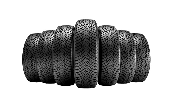 Set of used and dirty summer tires at tire service and car on a lift