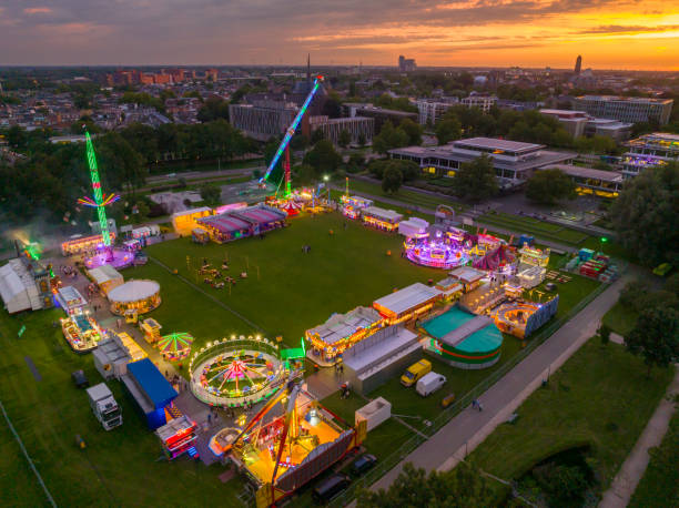 istock Fair during sunset with illuminated fairground attractions seen from above 1643975166