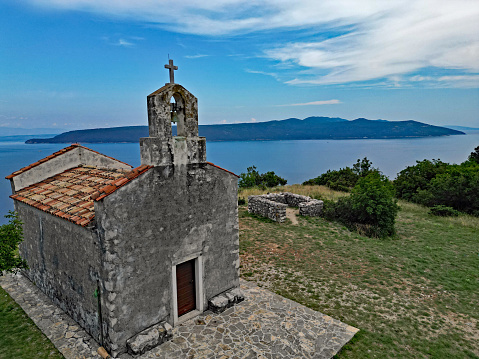 Aerial view of Island Cres from the top of the cliff with Church of St. Mary Magdalene in Brsec, Istria, Croatia.
