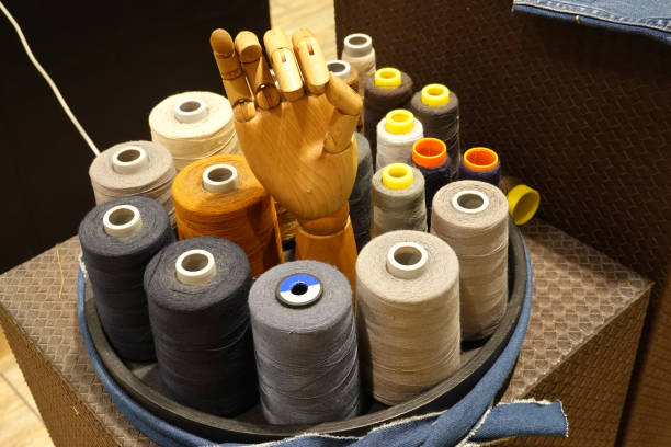istock A wooden hand and sewing accessories on black tray 1643991644