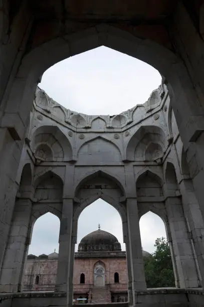 Photo of Ruins and pillars of marble tomb of Asharfi Mahal or The Madarsa, built by Hoshang Shah around 14th century, located in Mandu, Madhya Pradesh, India