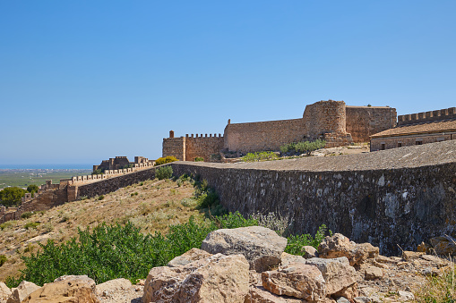 Historic Bahla Fort located at Djebel Akhdar highlands in the Sultanate of Oman against blue sky.