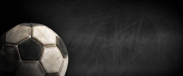 Old Soccer Ball on a Blank Blackboard with Copy Space stock photo