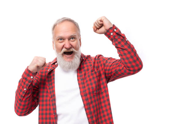 istock satisfied 60 year old gray-haired pensioner man with a beard and mustache 1644005192