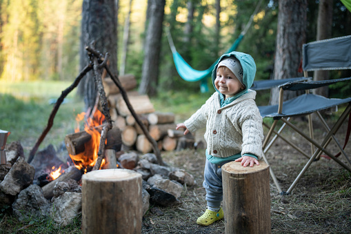 Shot of happy and playful baby boy on camping in nature.