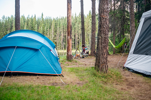 Mother and son near campfire on camping.