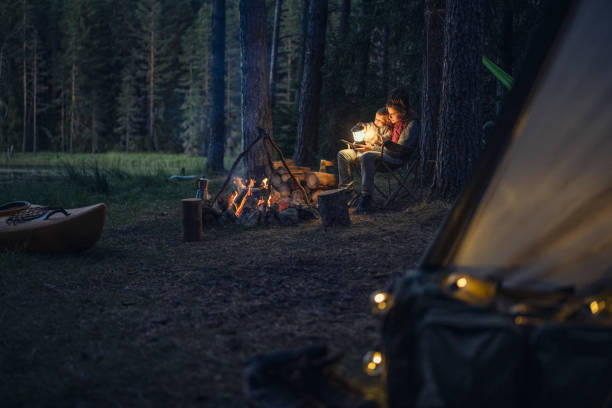 istock Young mother and her son on camping at night. 1644005342