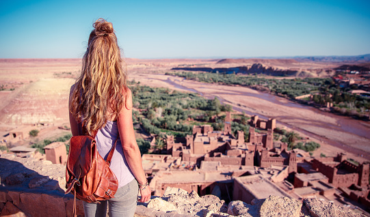 Traveler woman in Morocco- Ait ben haddou city landscape view, desert oasis