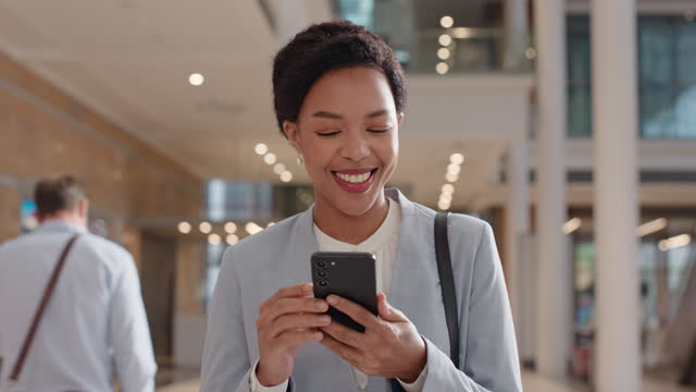 Phone, business and smile with black woman and walking for communication, social media and contact. Technology, email and website with employee at hotel for conference, schedule and mobile app