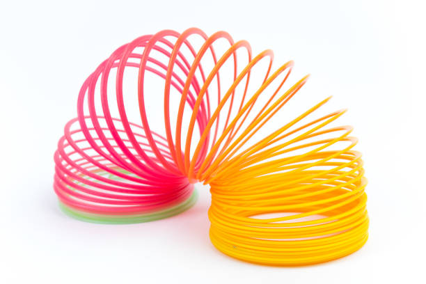 istock Rainbow colored wire spiral toy on white background. 1644028904