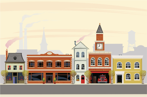 This is a vector illustration of any town main street. The scene is set in the morning with a number of victorian buildings conceived in a retro style. Smoke stacks and smokey chimneys give this an early fall look with cool weather.