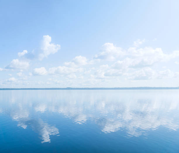 istock natural landscape, waterscape with large water body under a blue sky with clouds and a distant wooded shore 1644043661