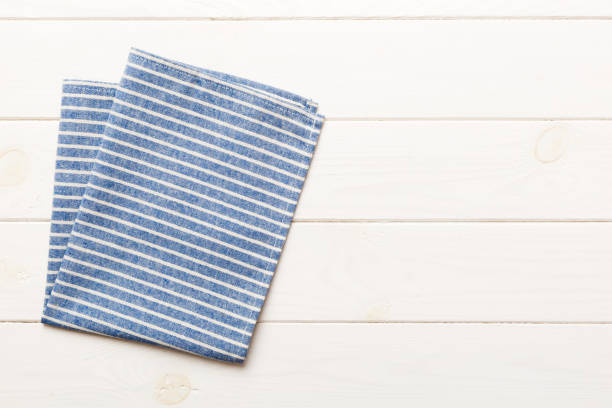 istock top view with blue kitchen napkin isolated on table background. Folded cloth for mockup with copy space, Flat lay. Minimal style 1644056185