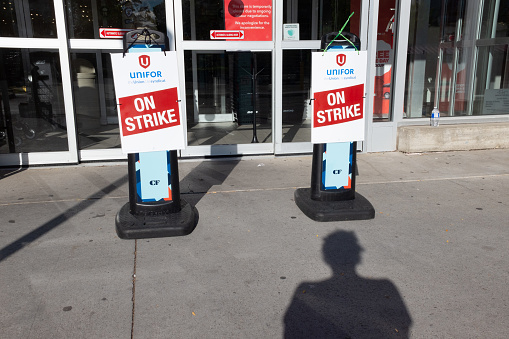 Toronto Ontario Canada  Metro grocery chain store front on strike with Unifor union flag outside the front entrance