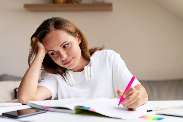istock Tired female university student doing homework at home. 1644093180