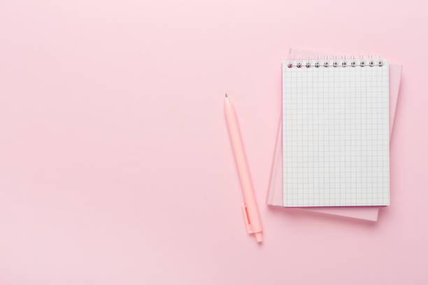 istock Notebooks with pen on color background, top view 1644097565